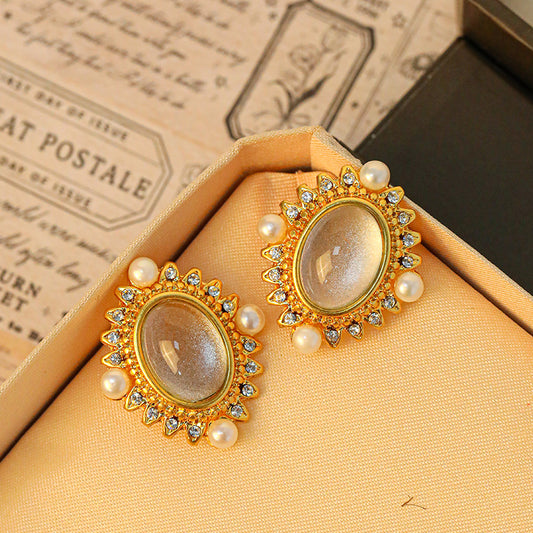 Oval gold-rimmed earrings